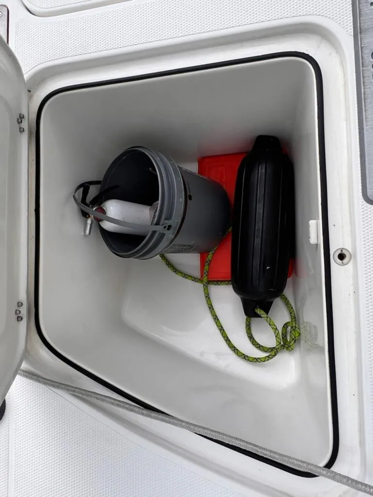 Slide: The Image of Storage compartment of a 2001 Rinalli 2100 Bay boat with bucket and accessories. - 10