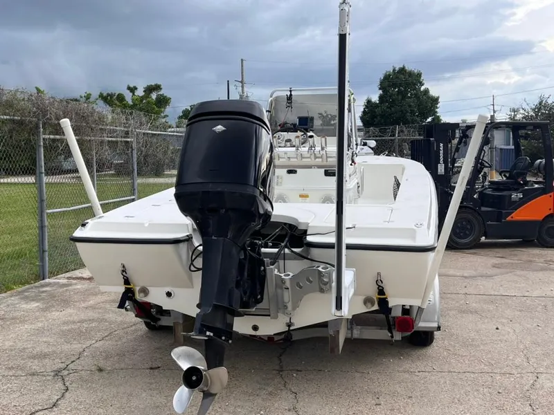 Slide: The Image of 2001 Rinalli 2100 Bay boat with outboard motor, parked on concrete. - 4