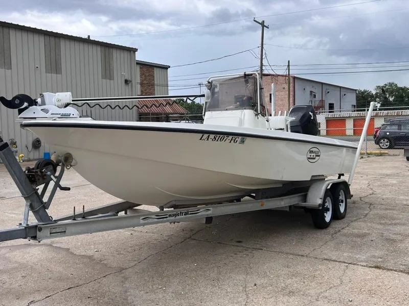 Slide: The Image of 2001 Rinalli 2100 Bay boat on a trailer in an industrial area. - 6