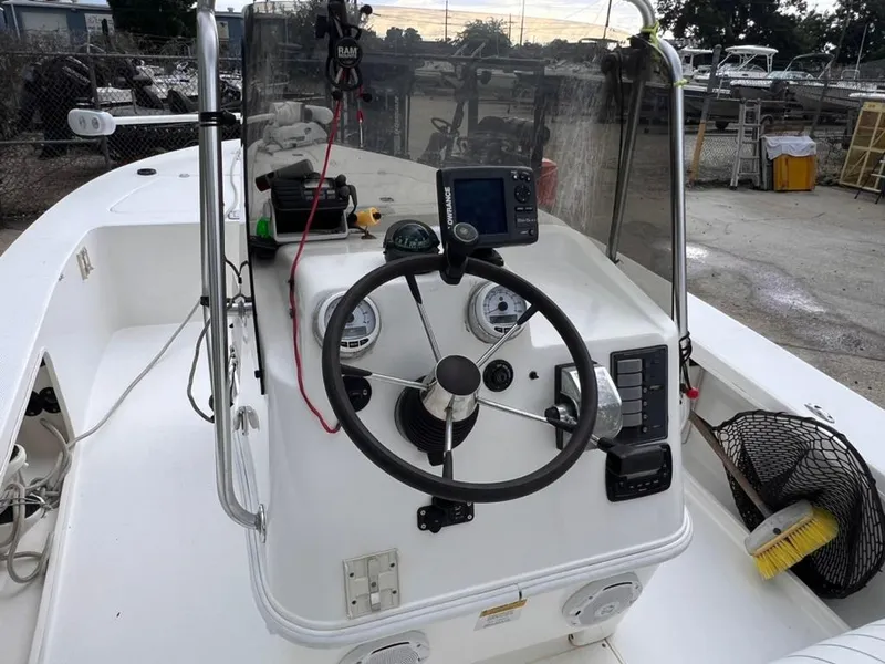 Slide: The Image of 2001 Rinalli 2100 Bay boat console with steering wheel and navigation equipment. - 8