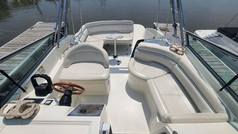 Slide: The Image of 1996 Doral 300 SC boat interior with white seating and wooden steering wheel. - 13
