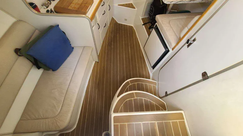 Slide: The Image of Interior of a 1996 Doral 300 SC boat with wood flooring and seating area. - 6