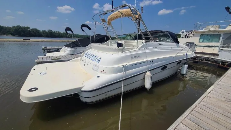 Slide: The Image of 1996 Doral 300 SC boat docked at marina under clear blue sky. - 9