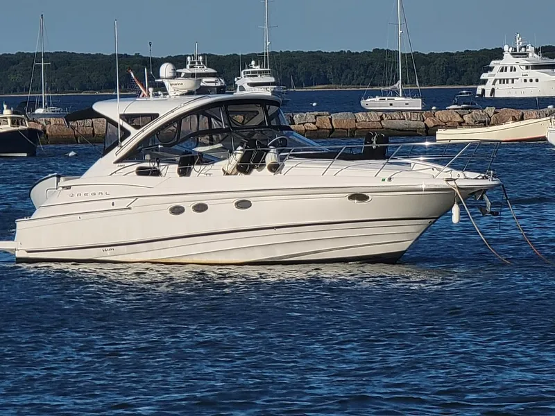 The Image of 2007 Regal Commodore 4460 yacht anchored in a marina with other boats. - 0