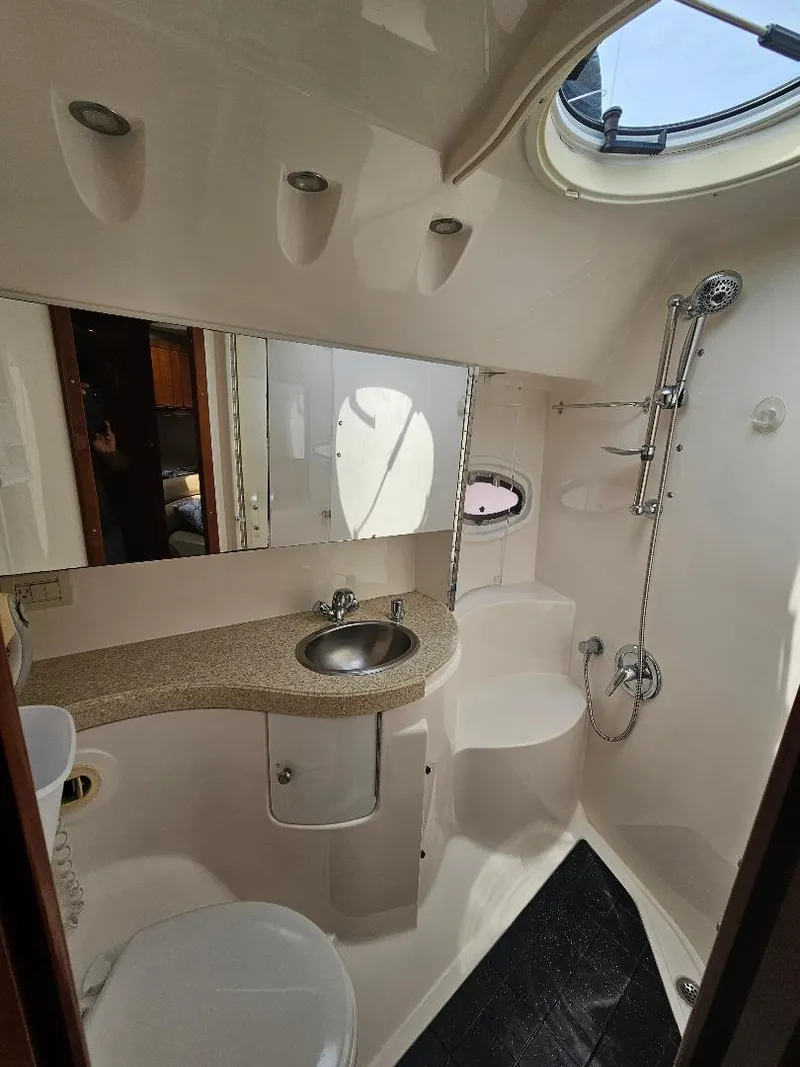 Slide: The Image of Bathroom interior of a 2007 Regal Commodore 4460 yacht with sink, mirror, and shower. - 18