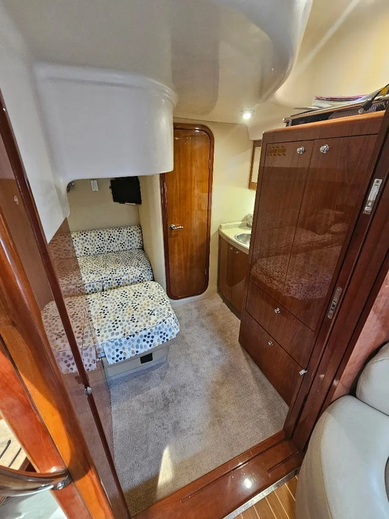 Slide: The Image of Interior cabin of a 2007 Regal Commodore 4460 yacht with bed and wooden cabinetry. - 21