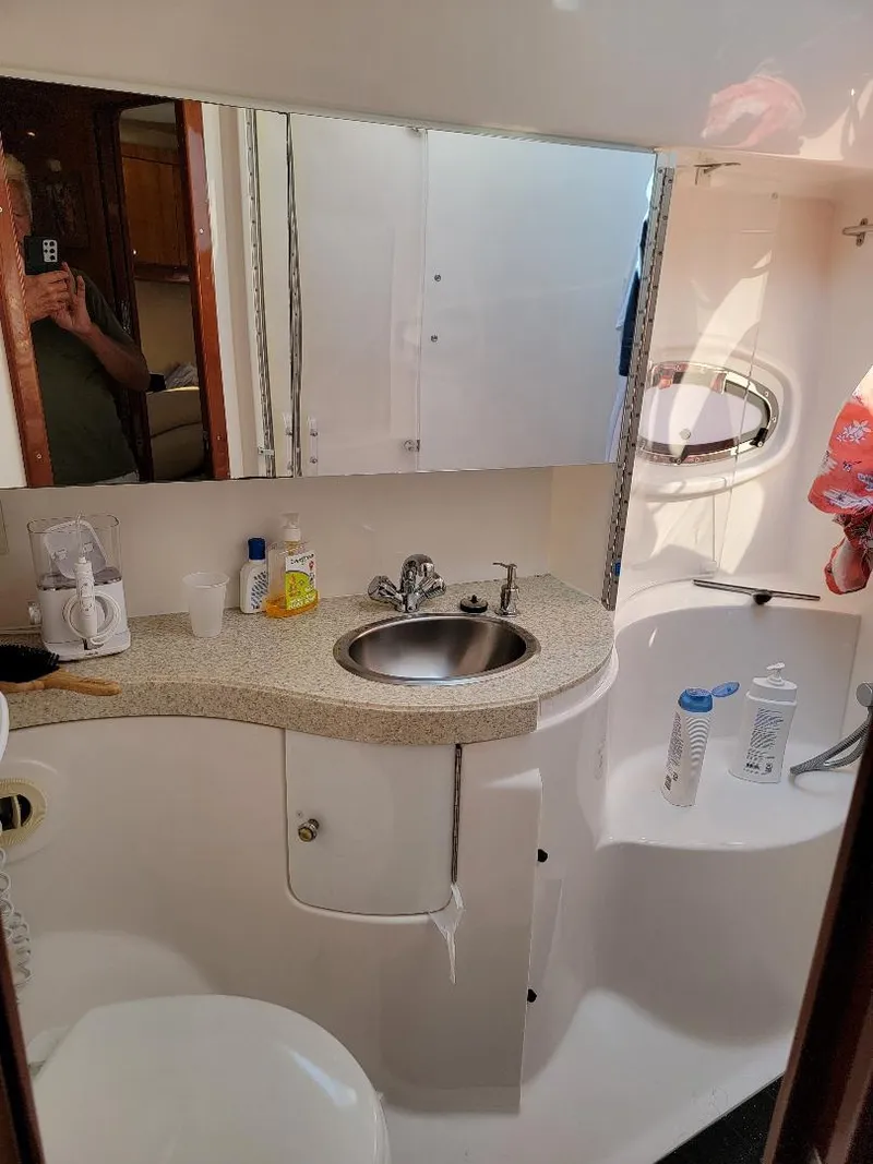 Slide: The Image of 2007 Regal Commodore 4460 bathroom with sink, mirror, and toiletries. - 23
