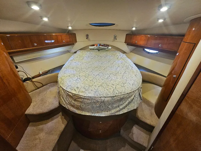 Slide: The Image of Luxurious cabin interior of 2007 Regal Commodore 4460 yacht with cozy bed and wooden cabinets. - 25