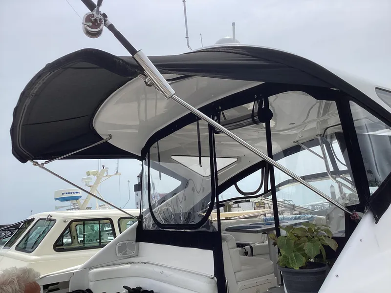 Slide: The Image of 2007 Regal Commodore 4460 yacht with black canopy at marina. - 27