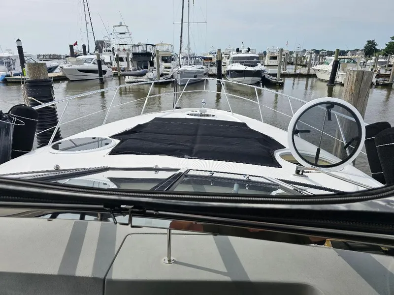 Slide: The Image of 2007 Regal Commodore 4460 yacht docked at a marina. - 28