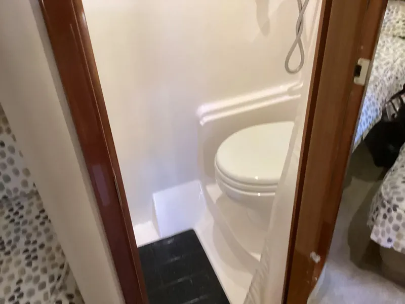Slide: The Image of 2007 Regal Commodore 4460 yacht bathroom interior with toilet and shower. - 31