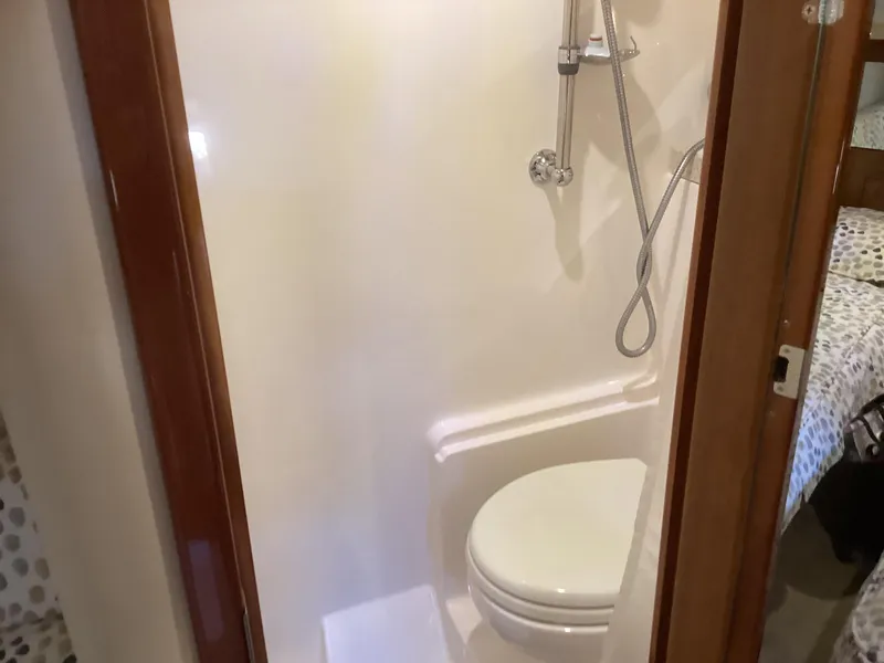 Slide: The Image of Compact bathroom in 2007 Regal Commodore 4460 yacht with shower and toilet. - 32