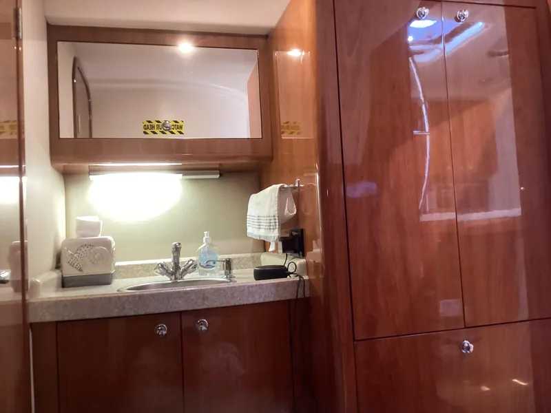 Slide: The Image of Luxurious 2007 Regal Commodore 4460 yacht interior with wooden cabinetry and sink area. - 33