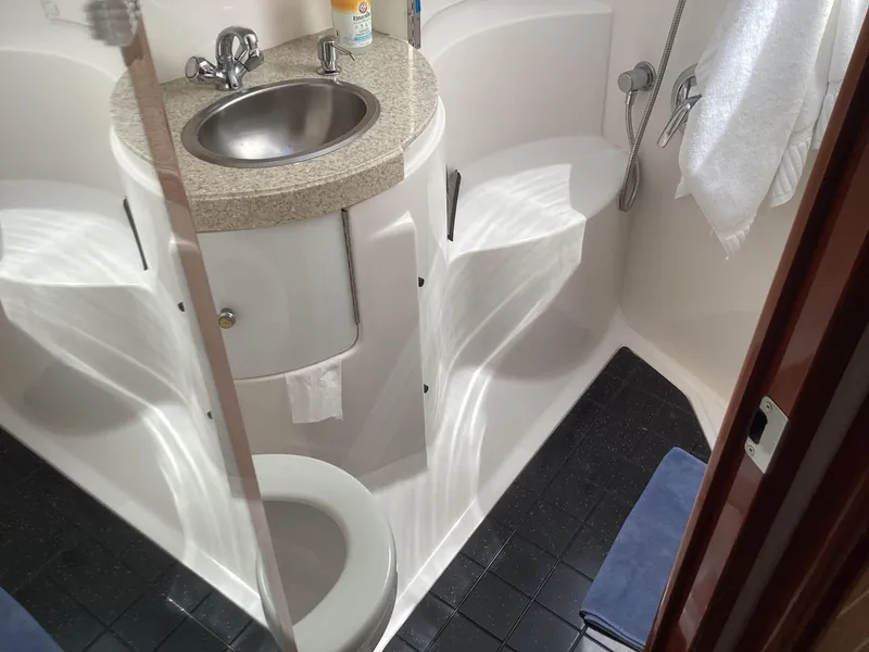 Slide: The Image of Compact bathroom in 2007 Regal Commodore 4460 yacht with sink, toilet, and shower. - 34