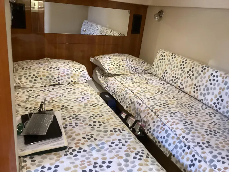 Slide: The Image of 2007 Regal Commodore 4460 cabin with twin beds and patterned bedding. - 37