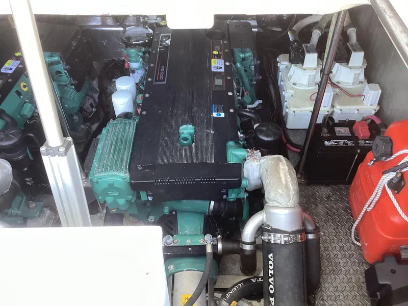 Slide: The Image of Engine compartment of 2007 Regal Commodore 4460 boat, featuring dual engines and battery setup. - 42