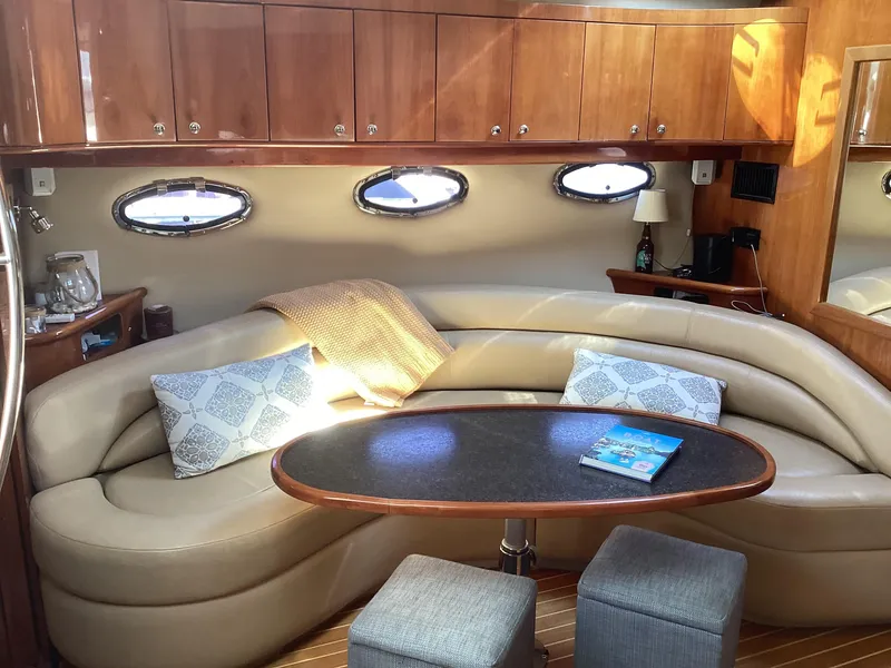Slide: The Image of Luxurious 2007 Regal Commodore 4460 yacht interior with elegant seating and wooden cabinetry. - 48
