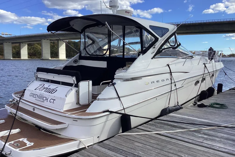 Slide: The Image of 2007 Regal Commodore 4460 yacht docked by a bridge on a sunny day. - 55