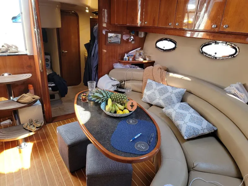 Slide: The Image of Interior of a 2007 Regal Commodore 4460 yacht with a cozy dining area. - 9