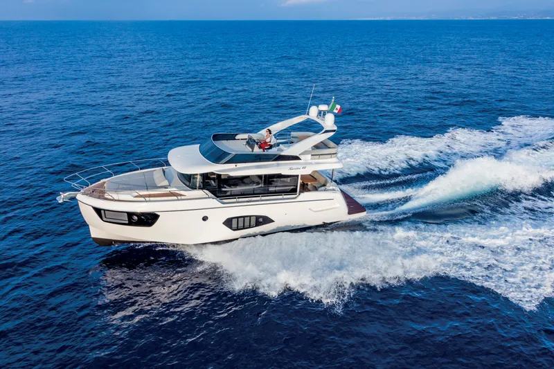 Slide: The Image of 2025 Absolute 48 Navetta yacht cruising on open sea. - 1