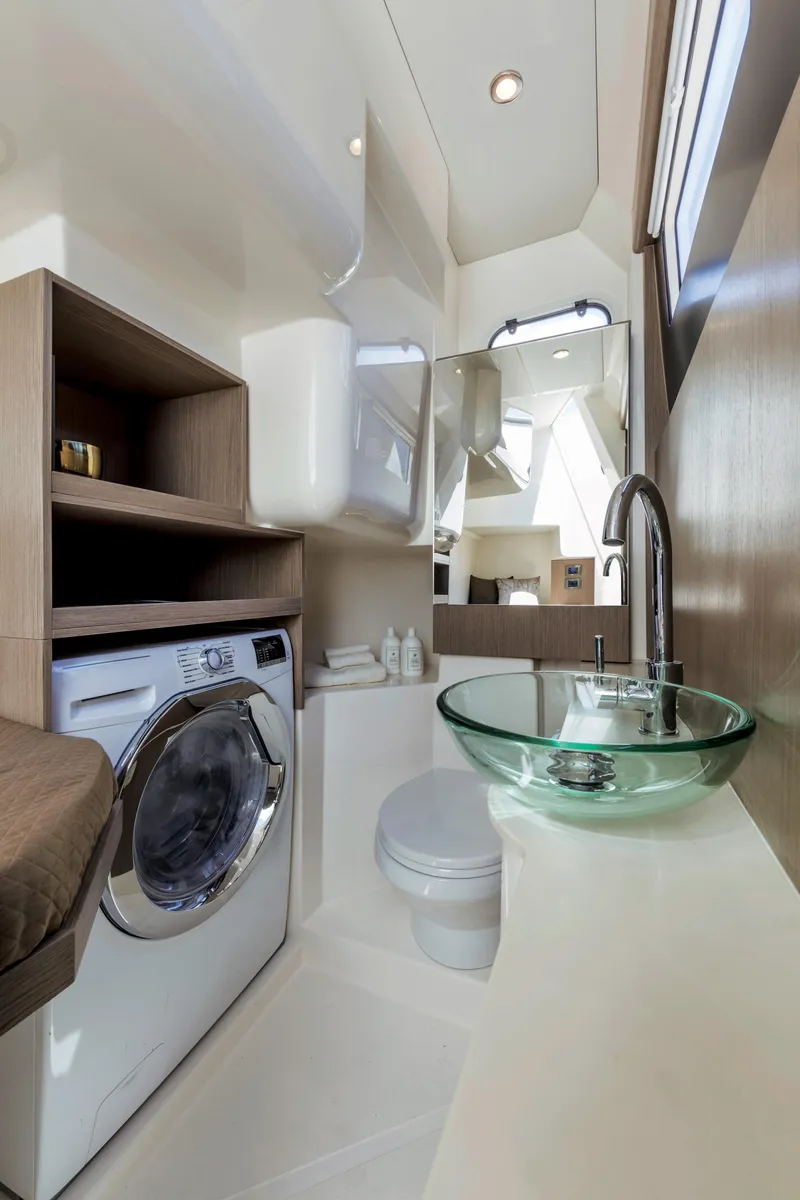 Slide: The Image of Modern bathroom in 2025 Absolute 48 Navetta yacht with glass sink and washing machine. - 16
