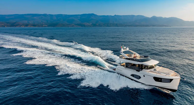 Slide: The Image of 2025 Absolute 48 Navetta yacht cruising on open water. - 2