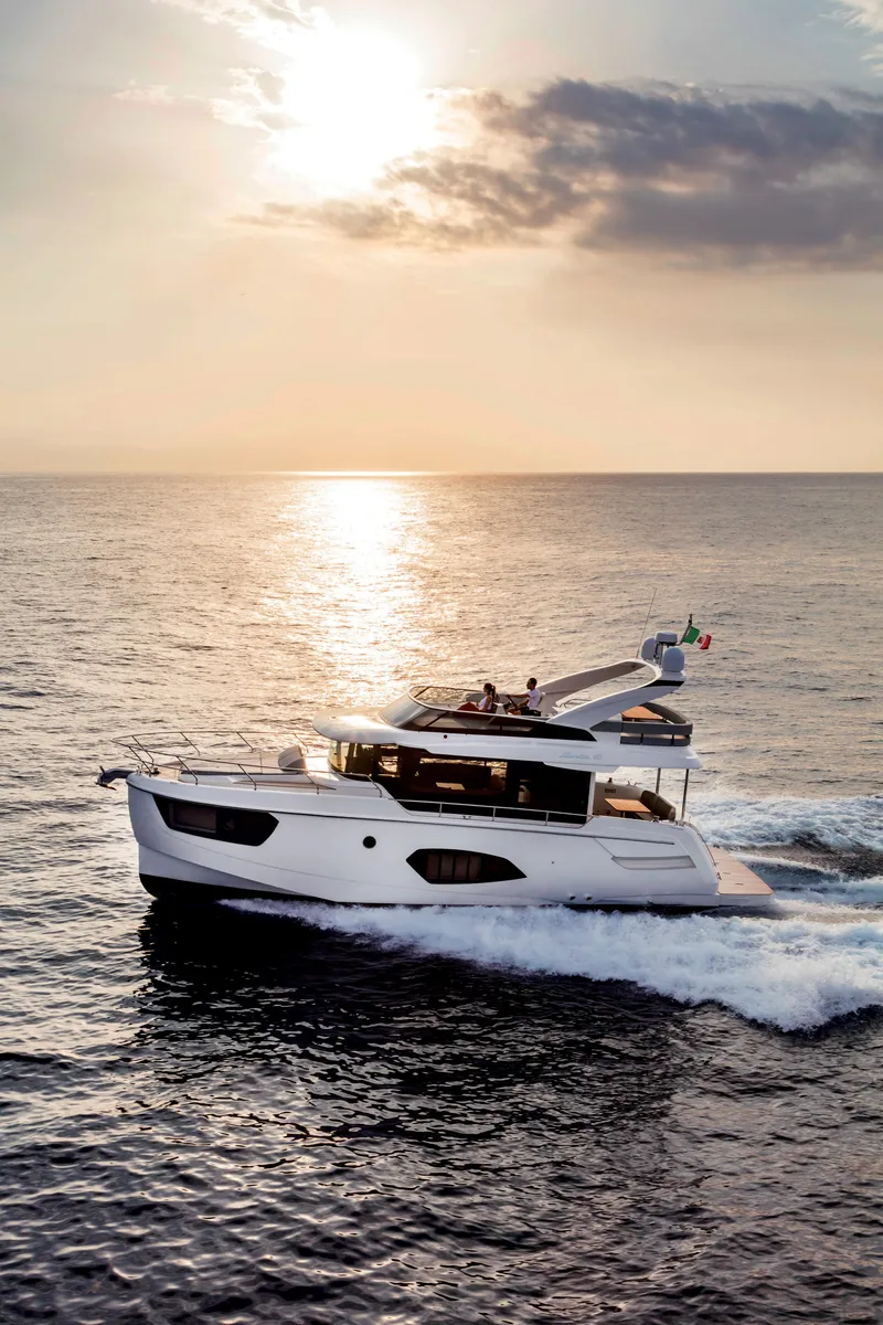 Slide: The Image of 2025 Absolute 48 Navetta yacht cruising at sunset on the open sea. - 3
