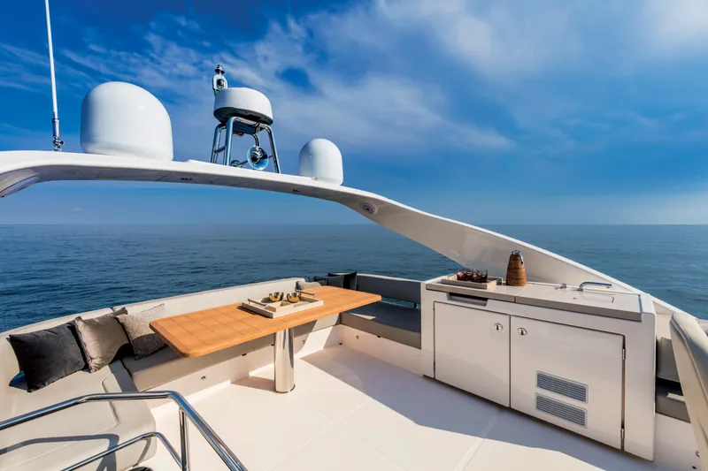 Slide: The Image of Absolute 48 Navetta 2025 yacht deck with ocean view and outdoor dining area. - 5