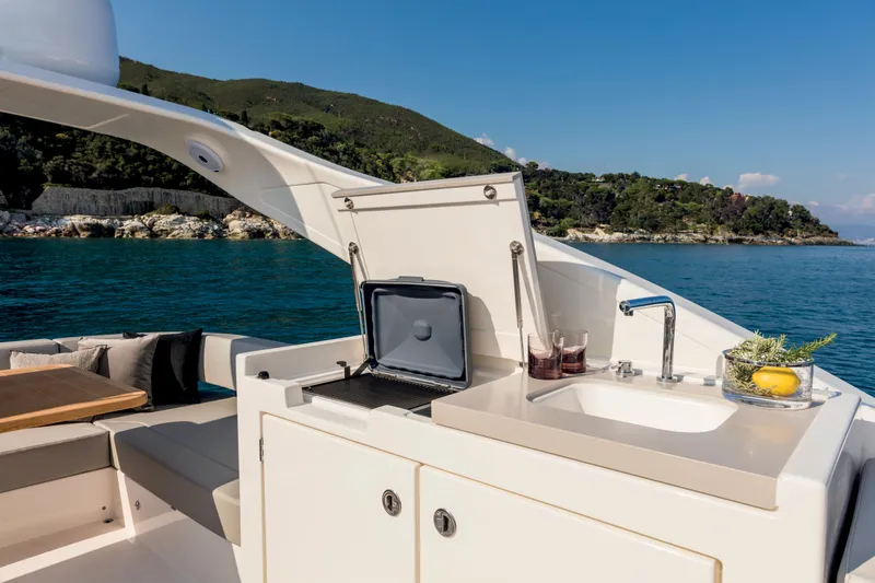 Slide: The Image of Outdoor kitchen on the 2025 Absolute 48 Navetta yacht with scenic ocean view. - 6
