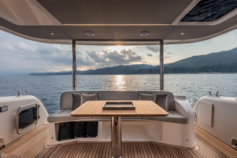 Slide: The Image of 2025 Absolute 48 Navetta yacht deck with ocean view at sunset. - 8