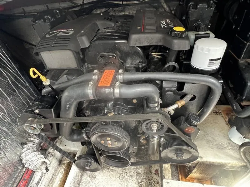 Slide: The Image of Engine of 1999 Cruisers Yachts 3375 Esprit, showcasing mechanical components and belts. - 2