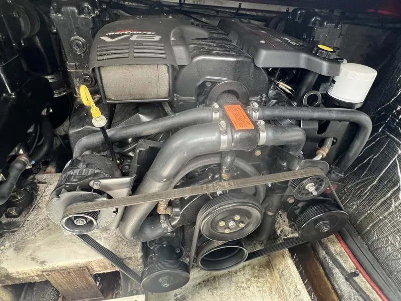 Slide: The Image of Engine of 1999 Cruisers Yachts 3375 Esprit, showcasing V8 components and belts. - 3