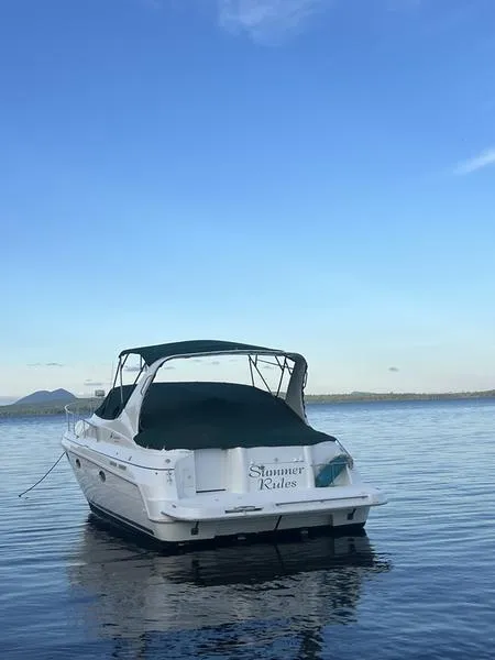Slide: The Image of 1999 Cruisers Yachts 3375 Esprit on calm water under clear blue sky. - 5