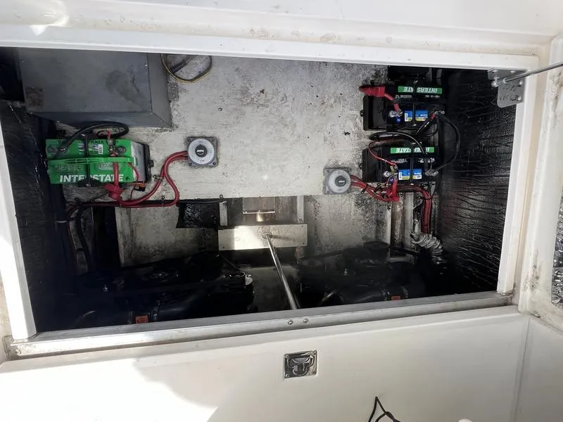 Slide: The Image of Engine compartment of 1999 Cruisers Yachts 3375 Esprit with visible batteries and wiring. - 6