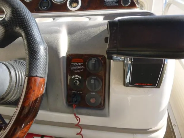 Slide: The Image of 2005 Sun Tracker Party Barge 27 I/O dashboard with steering wheel and controls. - 14