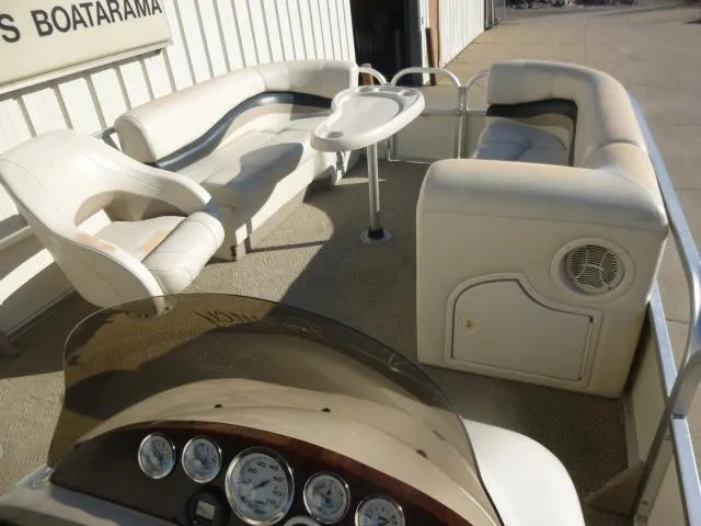 Slide: The Image of 2005 Sun Tracker Party Barge 27 I/O interior with seating and control panel. - 21