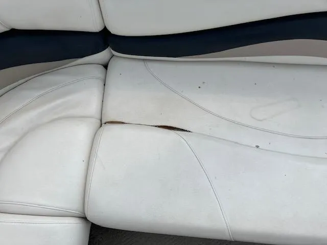 Slide: The Image of Torn white upholstery on 2005 Sun Tracker Party Barge 27 I/O boat seat. - 31