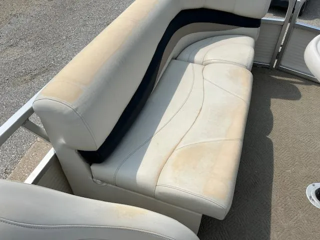 Slide: The Image of 2005 Sun Tracker Party Barge 27 I/O boat seating with visible wear and discoloration. - 34