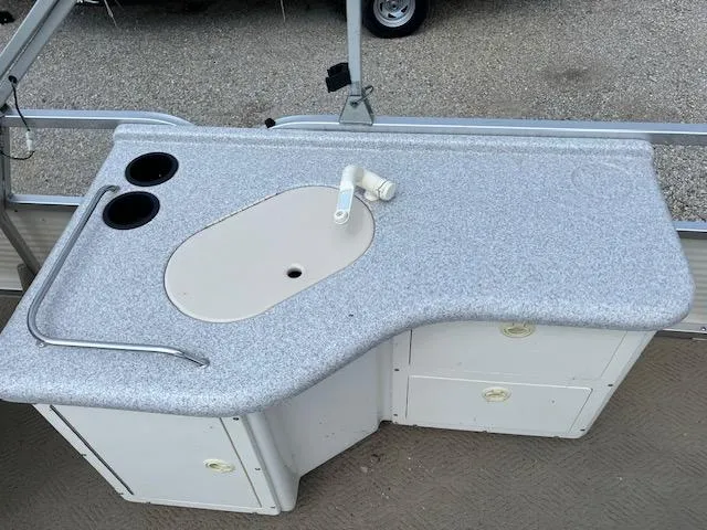 Slide: The Image of 2005 Sun Tracker Party Barge 27 I/O boat kitchen sink and counter area. - 37