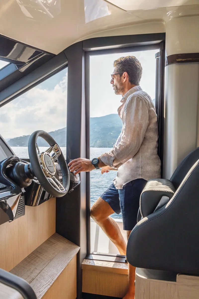 Slide: The Image of Man enjoying the view from the helm of a 2025 Absolute 47 Fly yacht. - 7