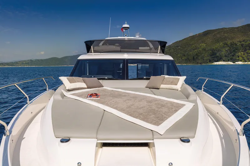 Slide: The Image of 2025 Absolute 47 Fly yacht with sunbathing area on the bow, scenic ocean view. - 9