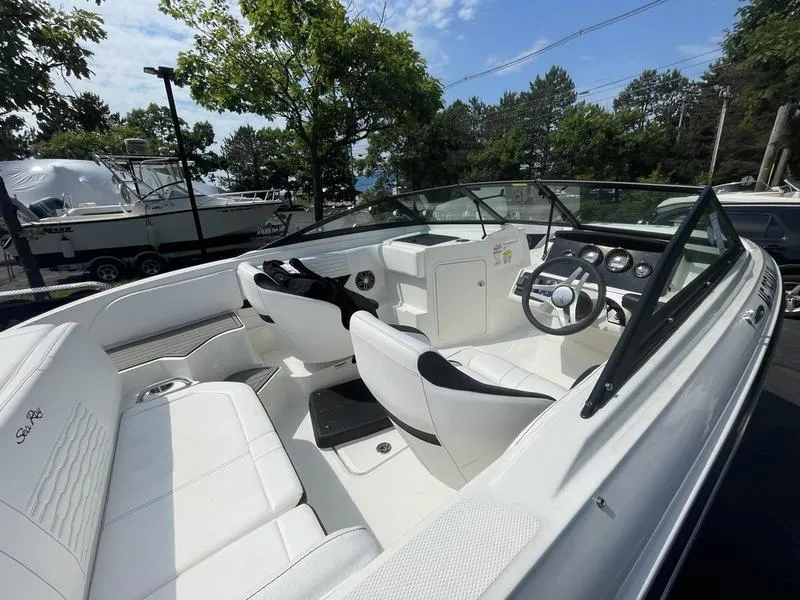 Slide: The Image of 2023 Sea Ray 190 SPX boat interior with white seating and modern dashboard. - 6