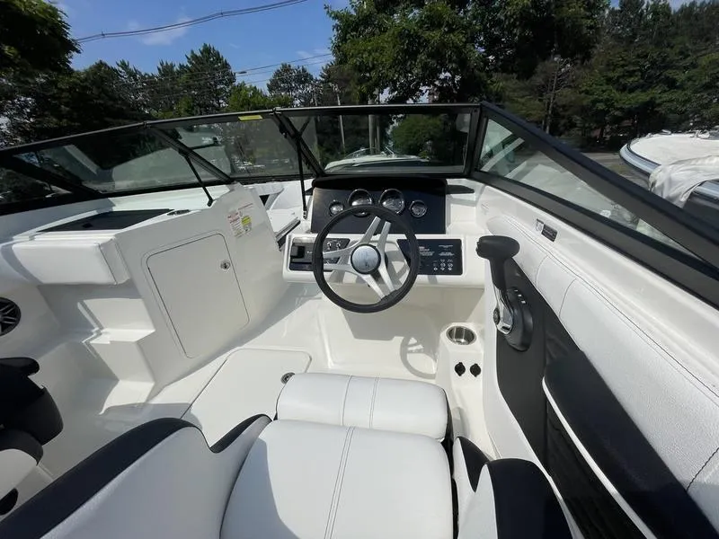 Slide: The Image of 2023 Sea Ray 190 SPX boat interior with steering wheel and dashboard. - 9