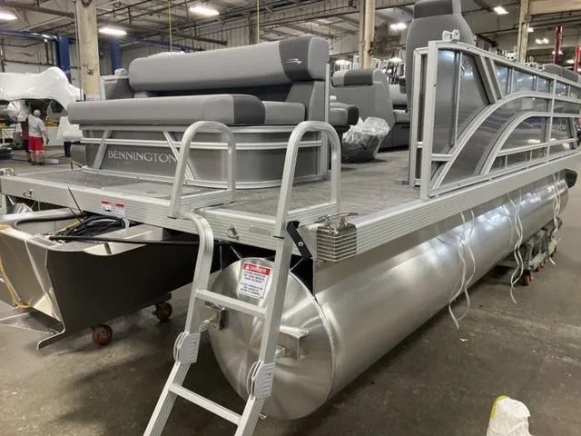 Slide: The Image of 2025 Bennington 188 SL L Bench Pontoon boat in a warehouse. - 5