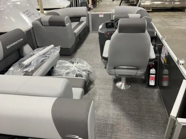 Slide: The Image of 2025 Bennington 188 SL L Bench Pontoon interior with grey seating and helm. - 6