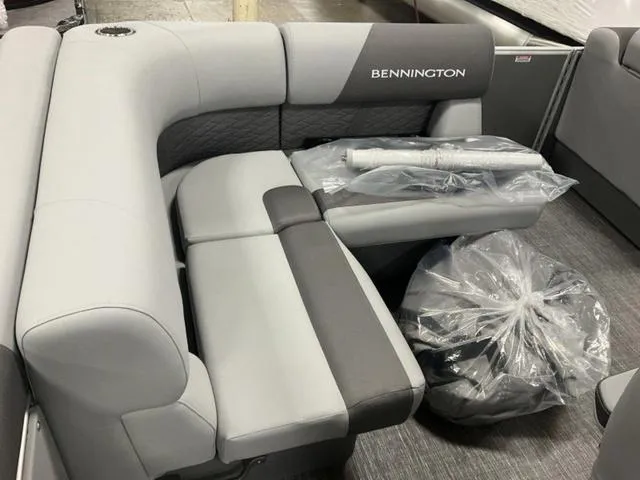 Slide: The Image of 2025 Bennington 188 SL L Bench Pontoon interior with gray and black seating. - 8