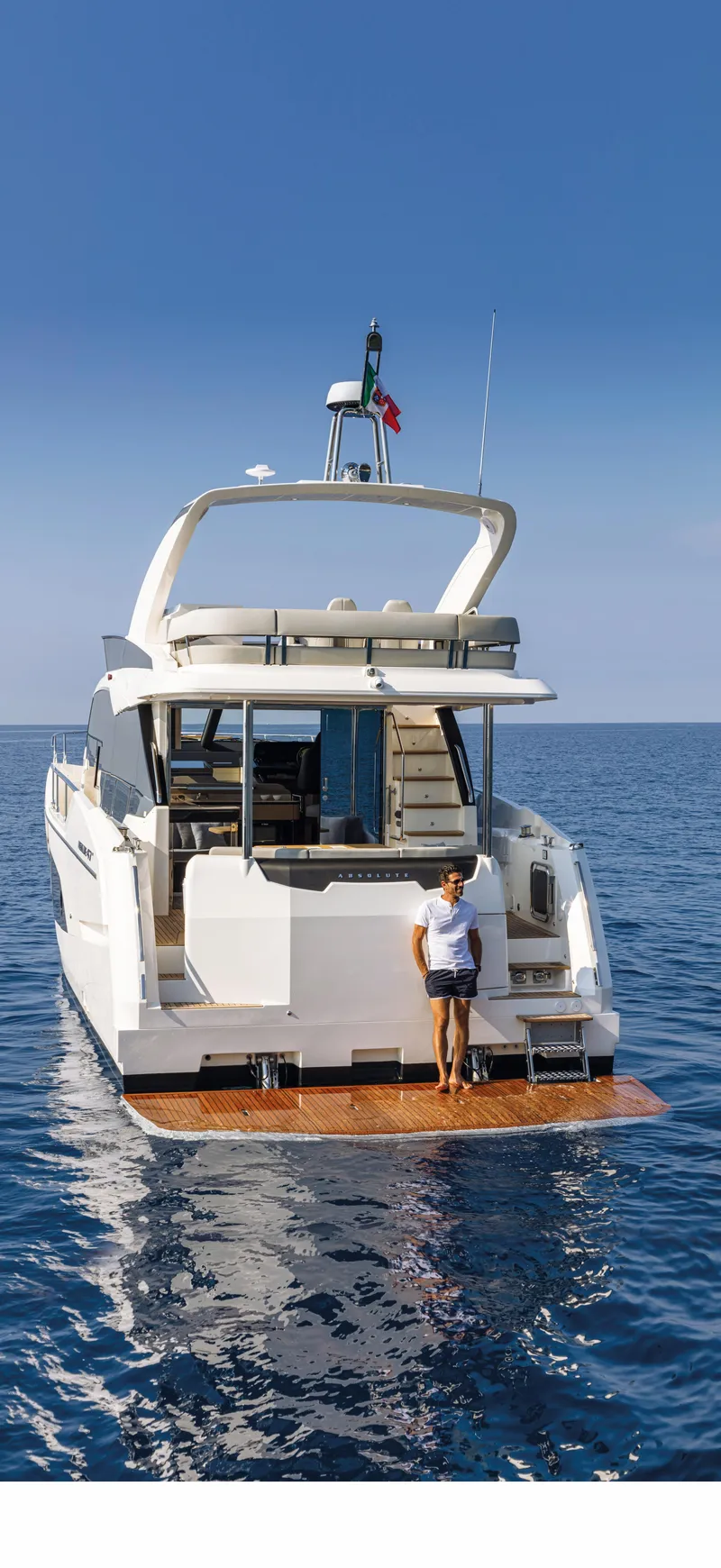 Slide: The Image of 2025 Absolute 47 Fly yacht on open water with a person on the swim platform. - 11