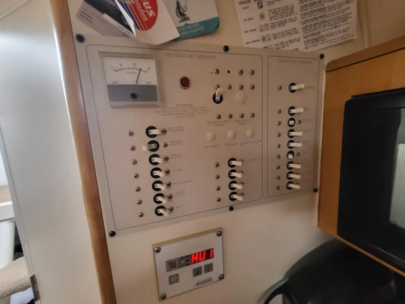 Slide: The Image of Electrical control panel inside a 2000 Larson Cabrio 290 boat cabin. - 19
