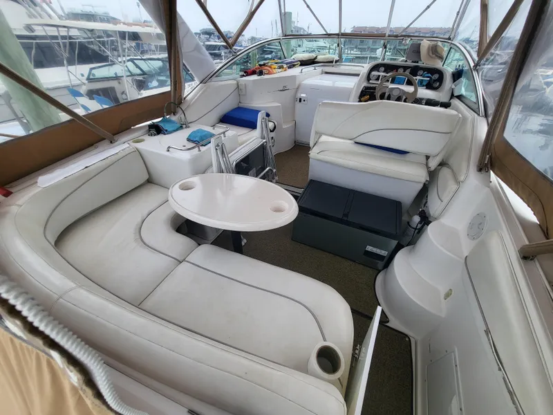 Slide: The Image of 2000 Larson Cabrio 290 boat interior with white seating and helm. - 3