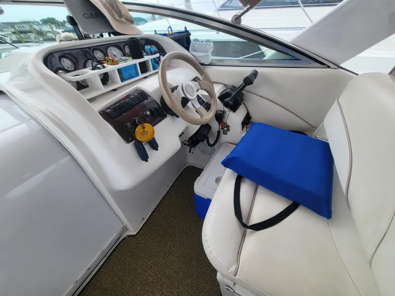 Slide: The Image of 2000 Larson Cabrio 290 boat cockpit with steering wheel and control panel. - 9